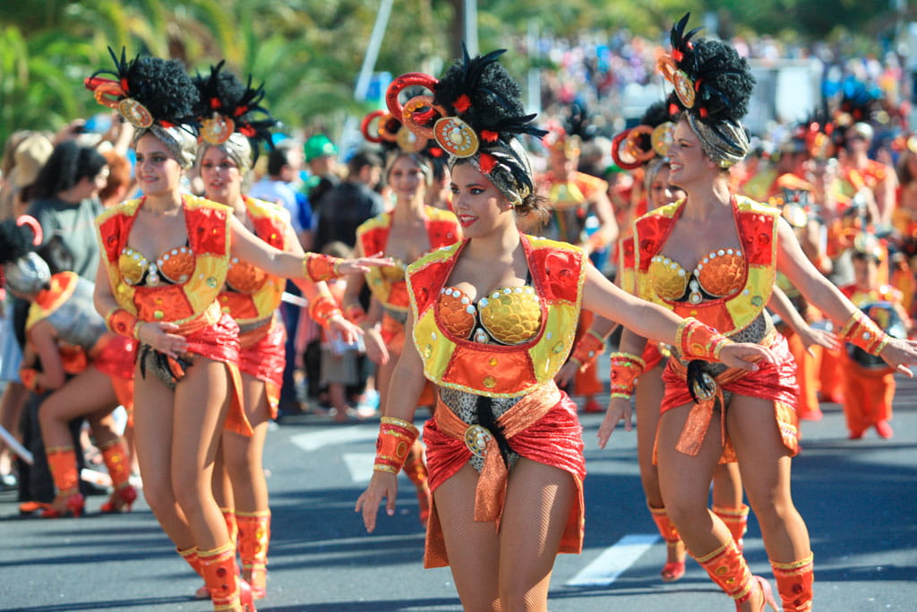 People parading in colorful costumes at the Carnival of Tenerife.