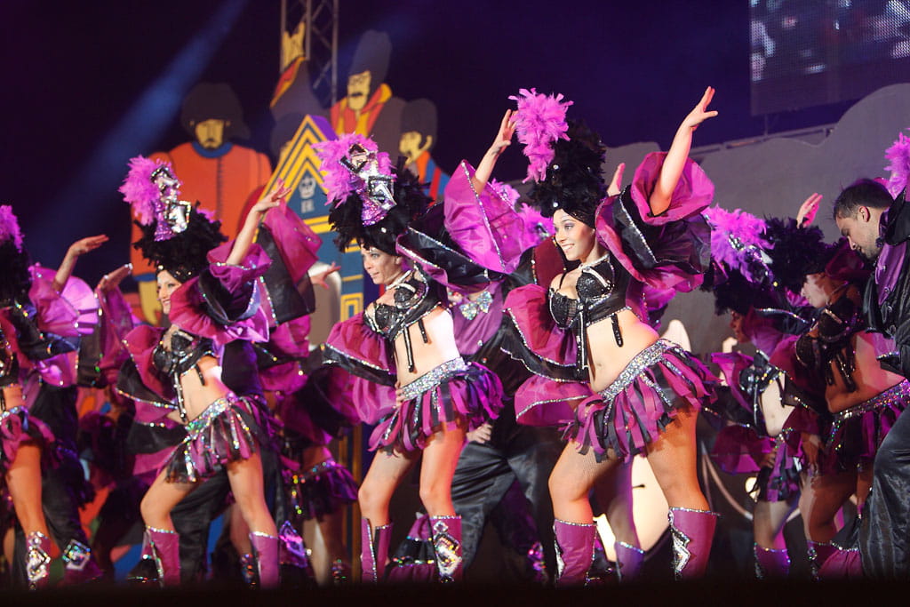 Dancers in colorful costumes performing during the Carnival of Tenerife.