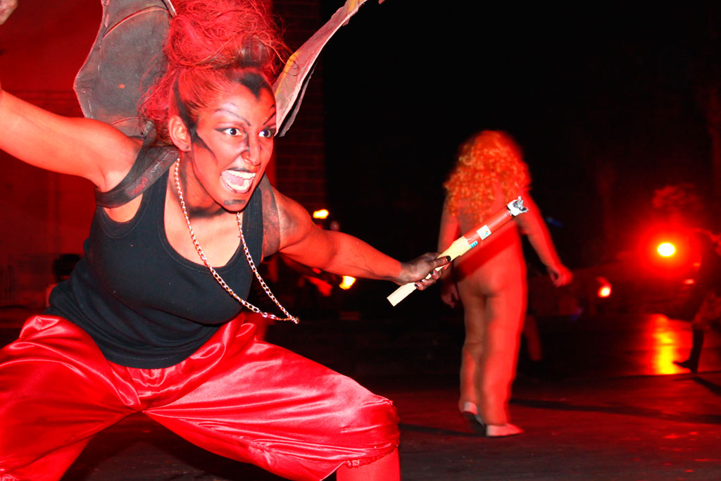 Person in demon costume performing at night event in Tenerife.