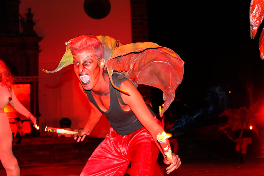 Person dressed as a demon with fireworks at a party in Tenerife.