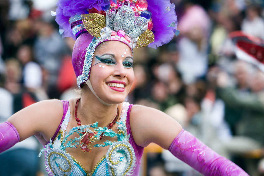 Smiling dancer in colorful costume at a Tenerife event.