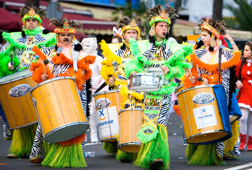 Group of costumed musicians play drums at an event in Tenerife.