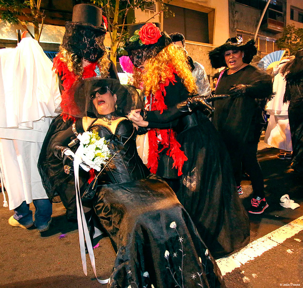 People in costumes at a night celebration in Santa Cruz de Tenerife.