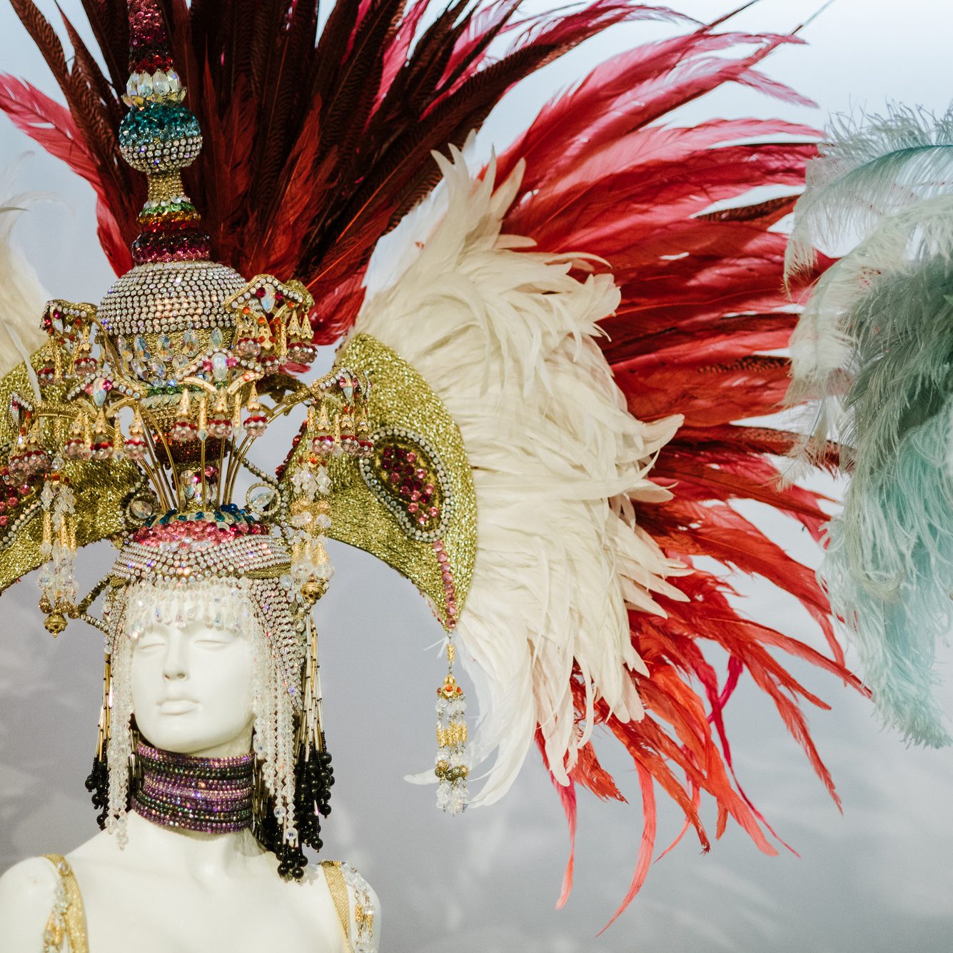 Mannequin with elaborate feather headdress and shiny beads at the Tenerife Carnival.