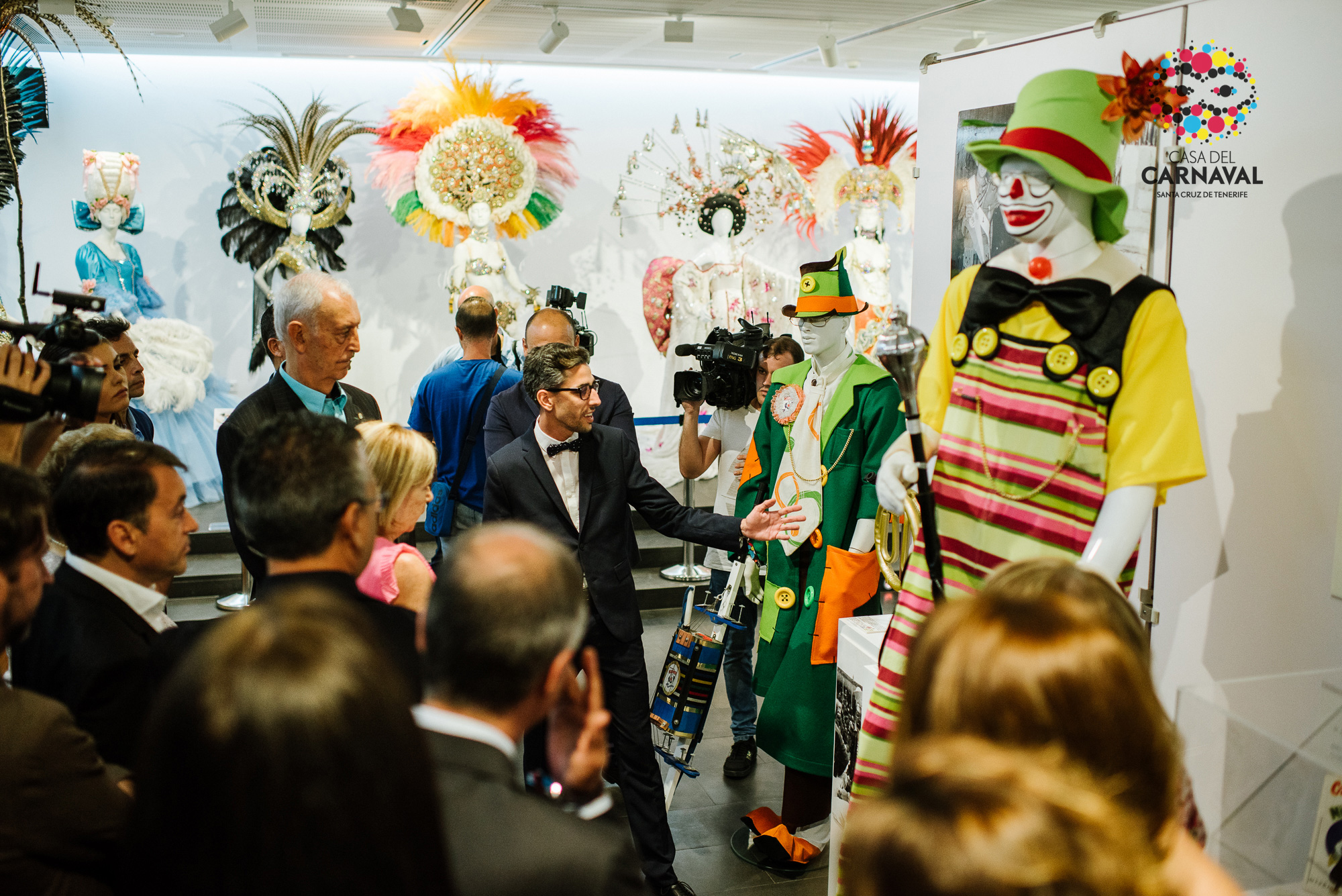 Group of people observing Carnival costumes in a venue in Santa Cruz de Tenerife.