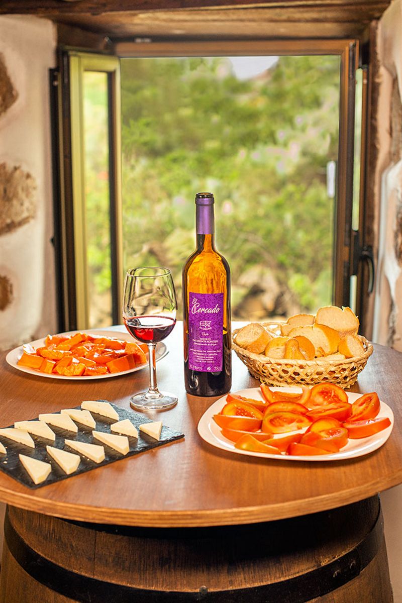 Bottle of El Cercado wine and snacks on the table in Tenerife.