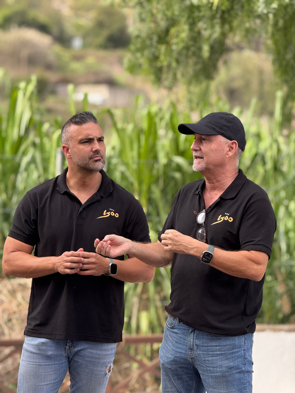 Two men talk in a green setting at Loro Parque, Tenerife.