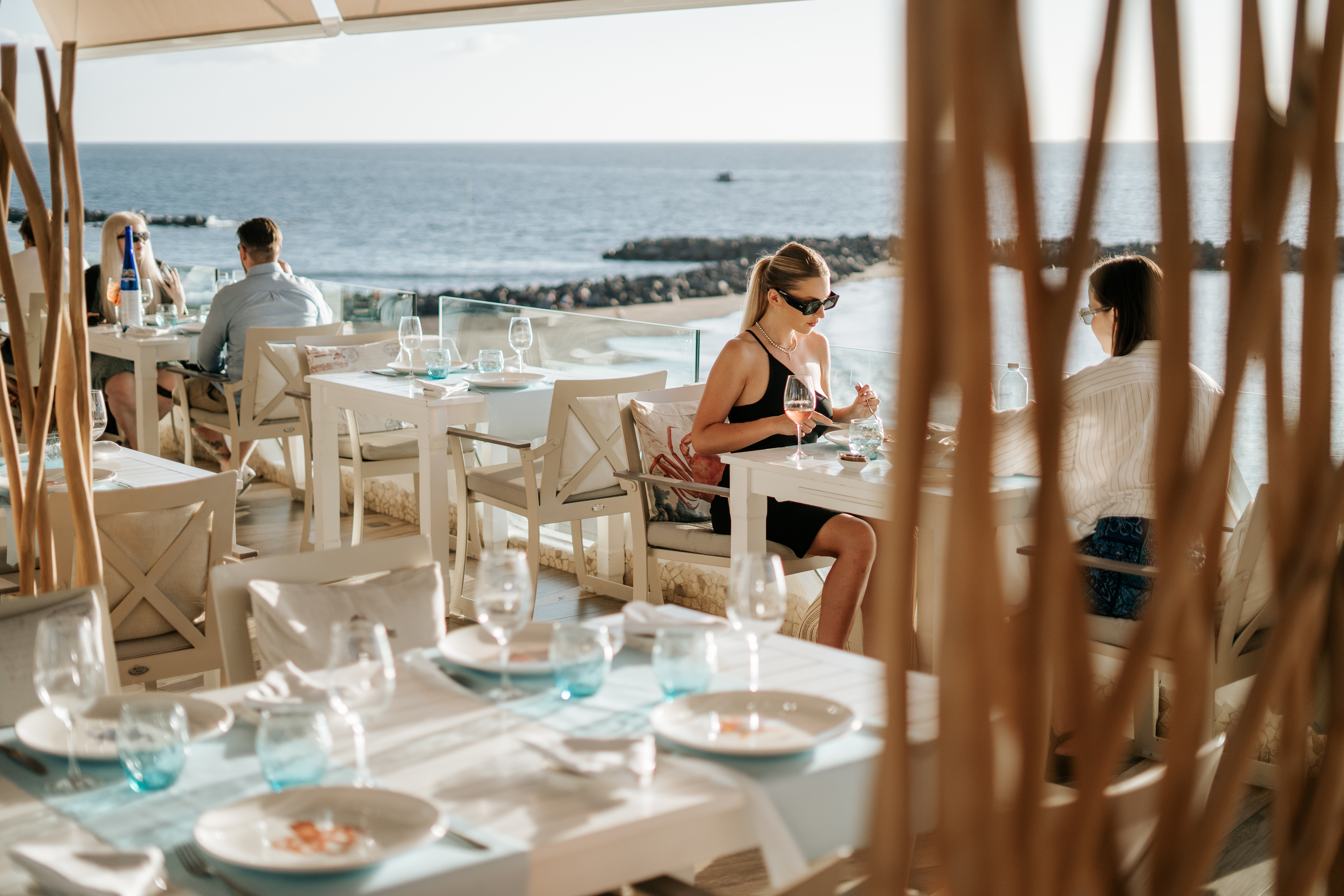 People dining at a restaurant overlooking the sea in Tenerife.