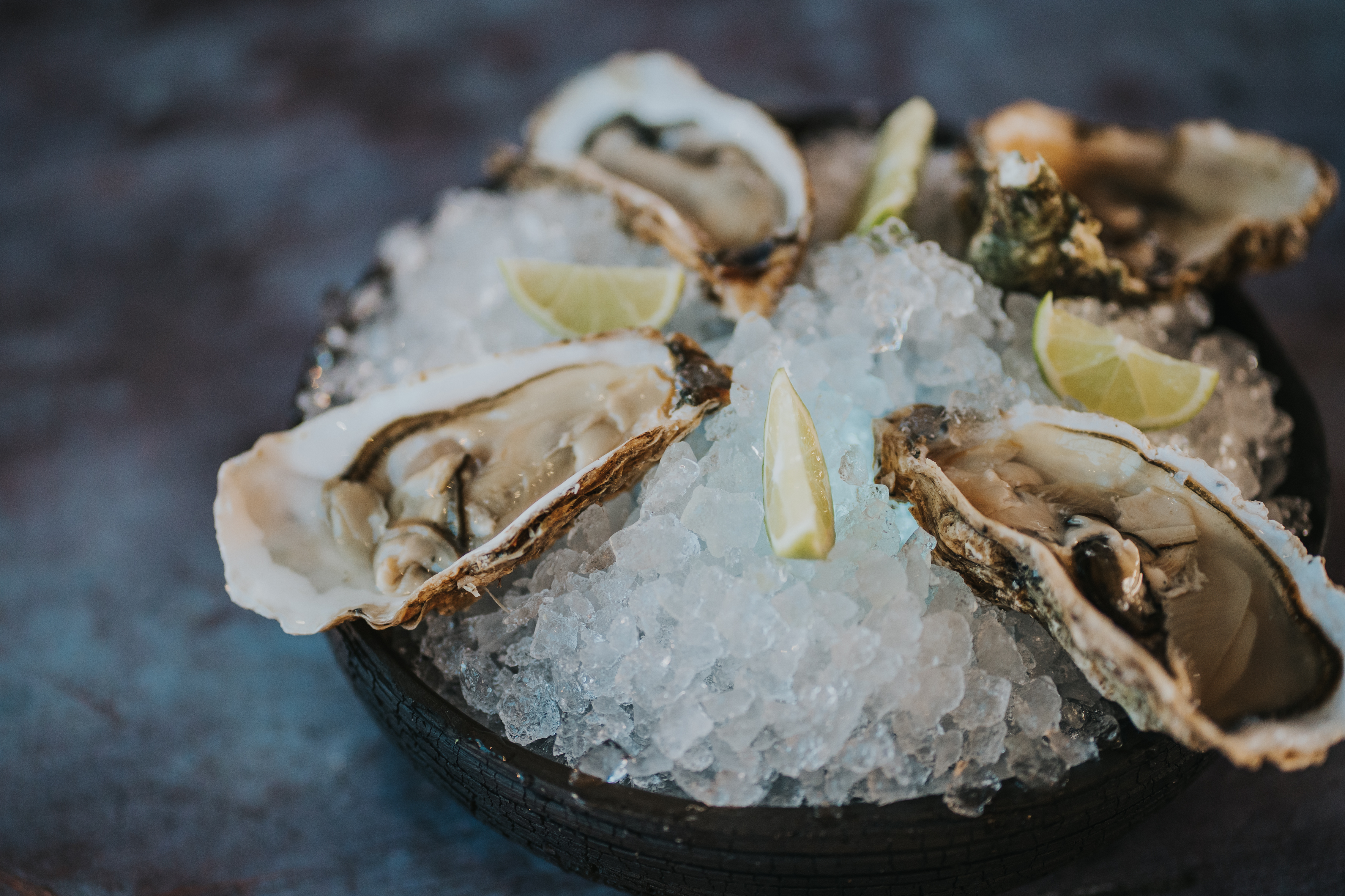 Oysters on ice with lemon slices, gourmet option in Tenerife.