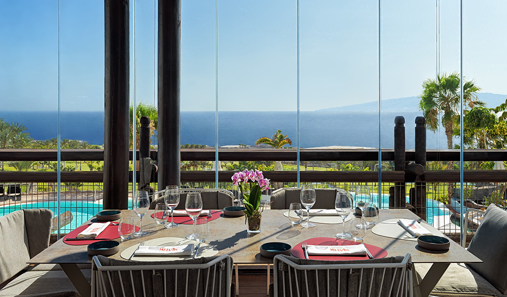 Table with crockery in restaurant with sea view in Tenerife.