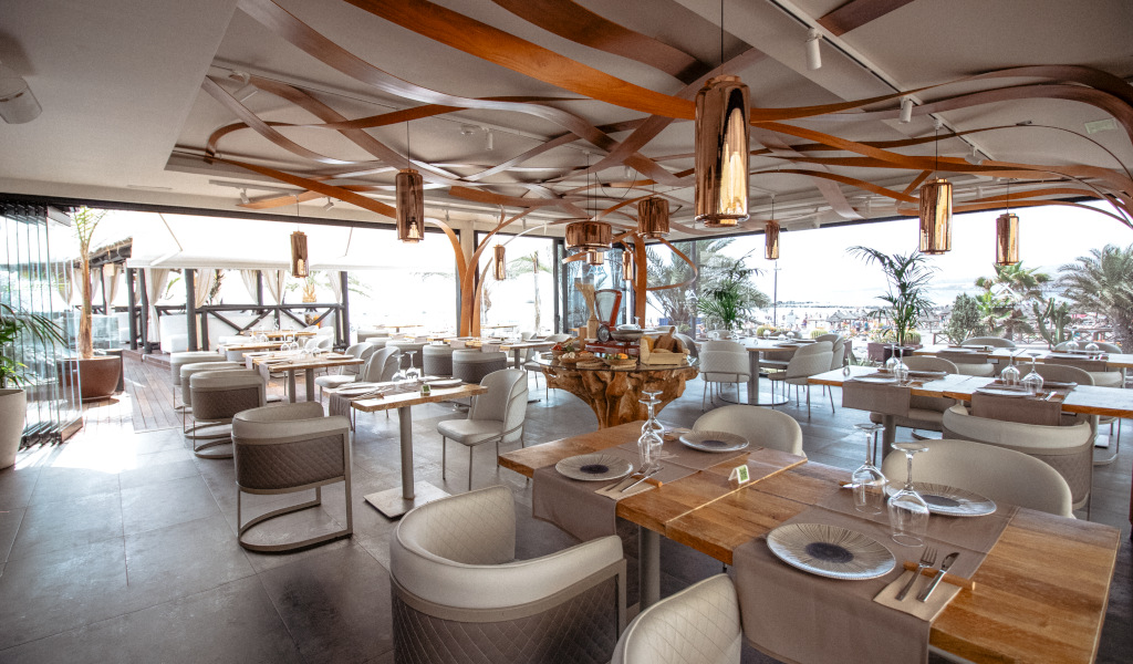Elegant restaurant with sea view in Tenerife, tables prepared for diners.