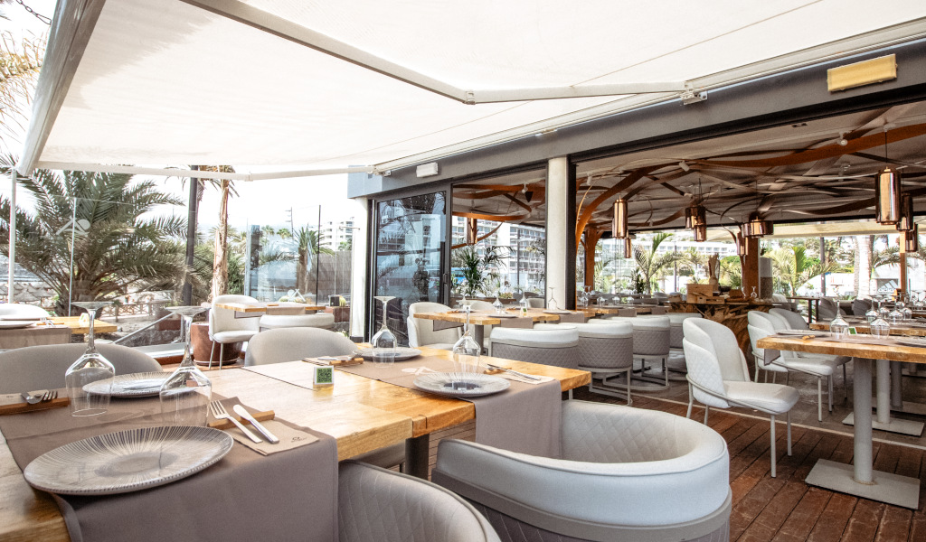 Open-air restaurant with tables and chairs in Tenerife.