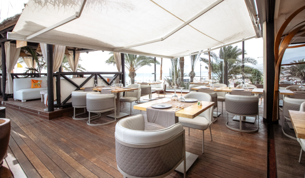 Restaurant terrace with sea views and outdoor seating in Tenerife.
