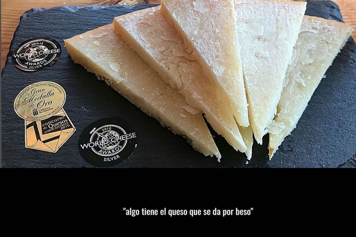 Award-winning cured cheese, Tenerife, with medals and text something about the cheese that is given for a kiss.