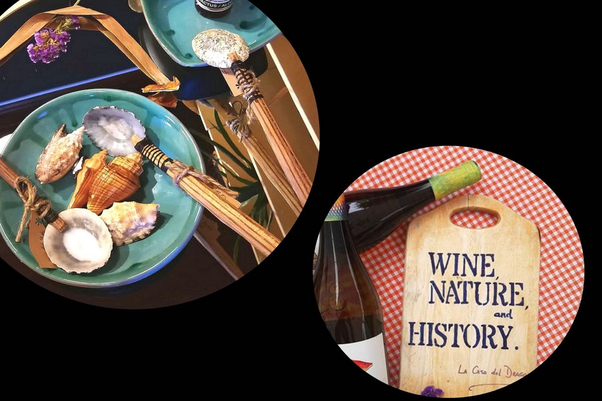 Plates of shells and bottle next to a table with text WINE, NATURE, and HISTORY in Tenerife.