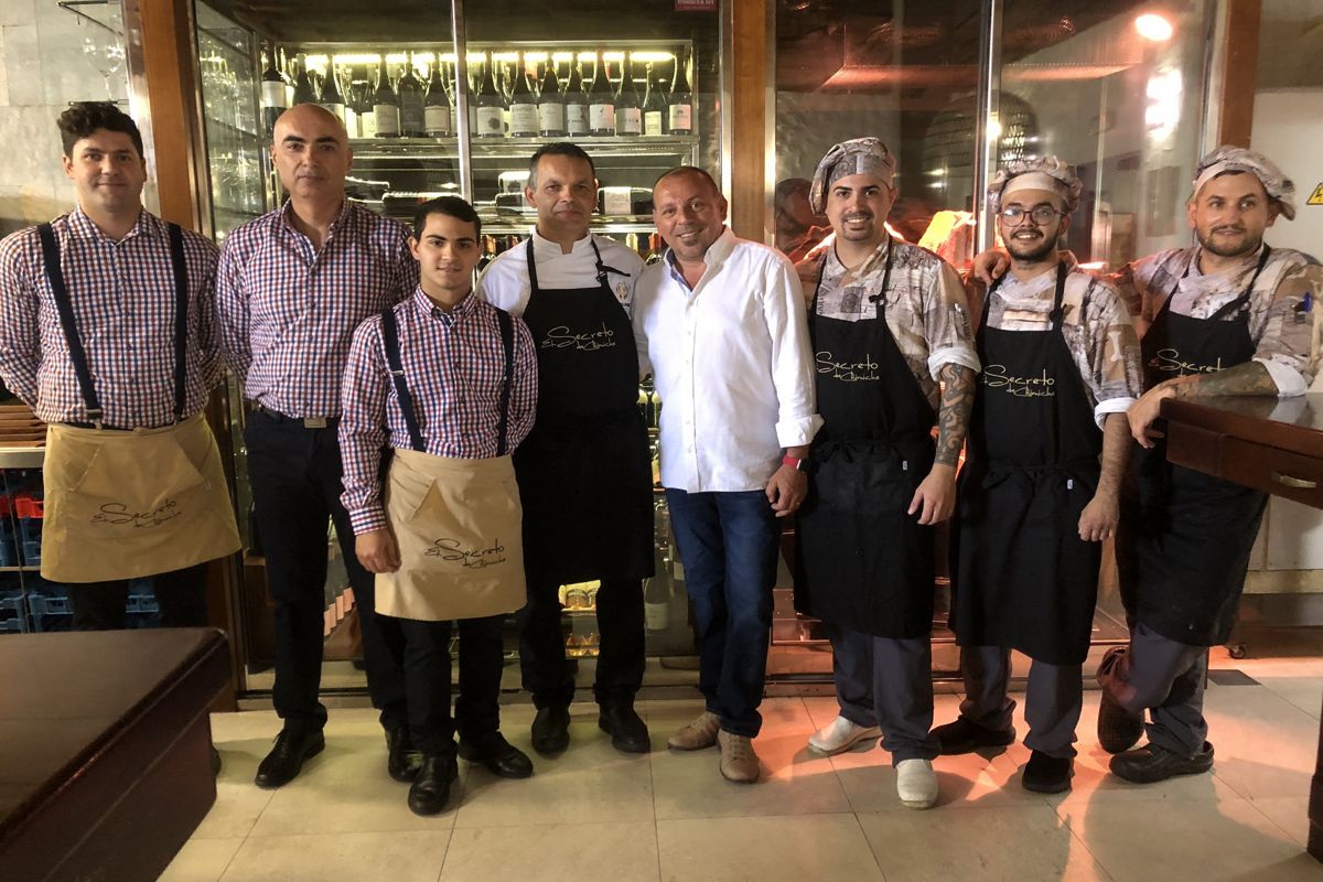 Chimiche's Secreto team in Tenerife, posing in front of a wine cellar.