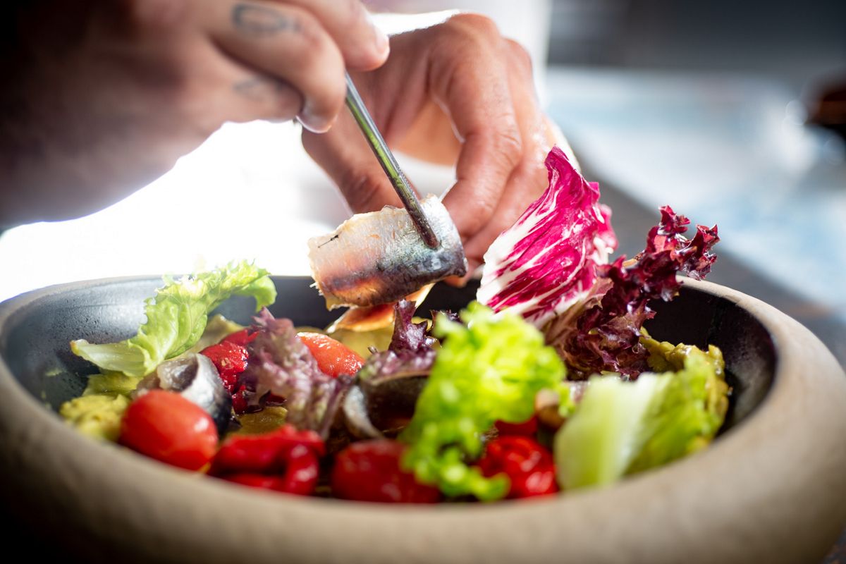 Preparation of a fresh salad with sardines in Tenerife.