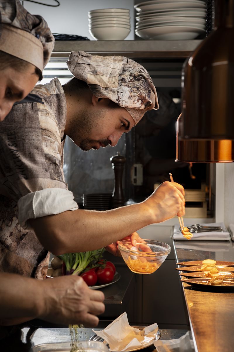 Chef preparing a dish in a restaurant kitchen in Tenerife.