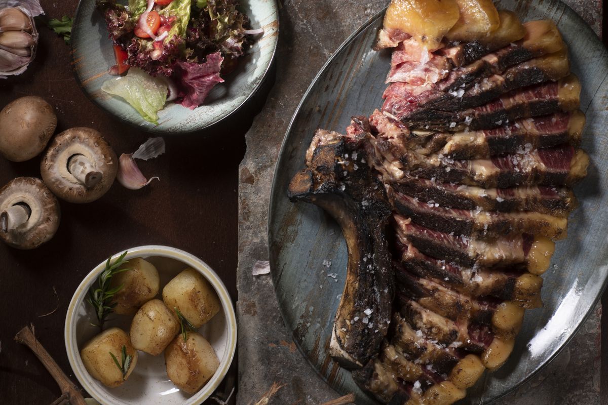 Roast meat dish accompanied by salad, mushrooms and potatoes in Tenerife.