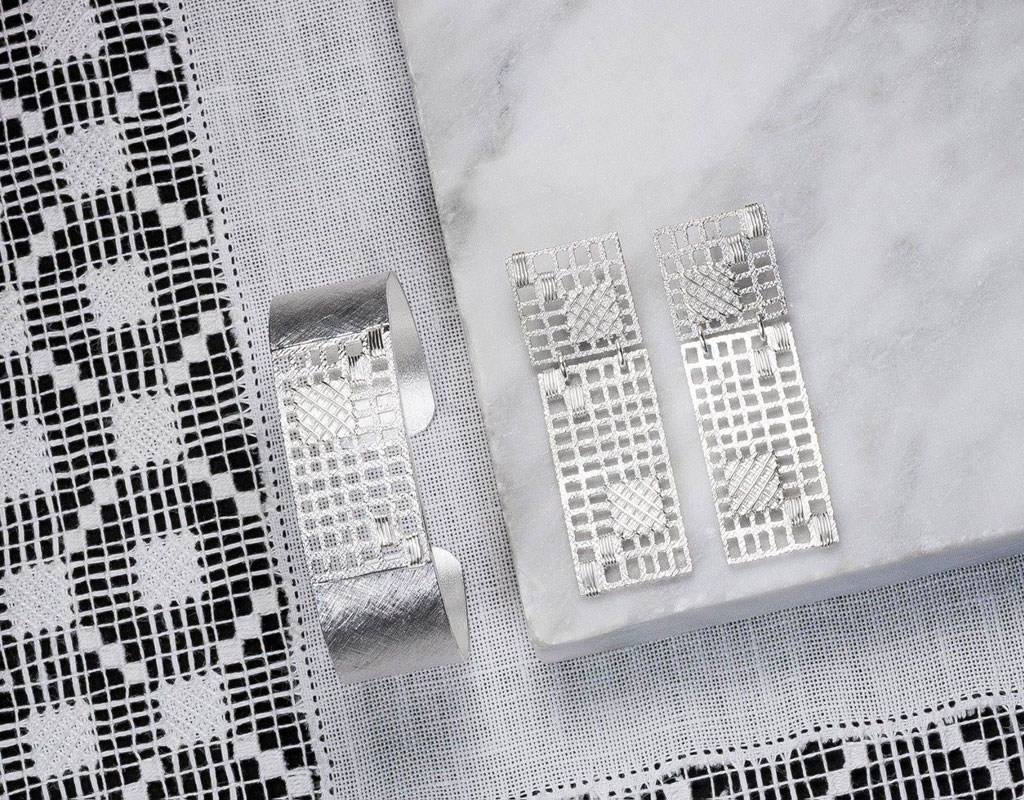 Filigree earrings and bracelet on embroidered fabric in Tenerife.