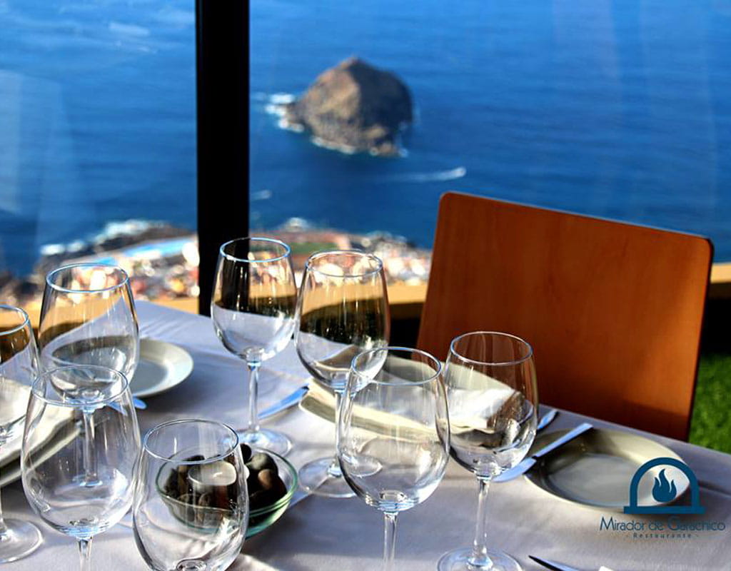Table with glasses and plates, sea view from the Mirador de Garachico, Tenerife.