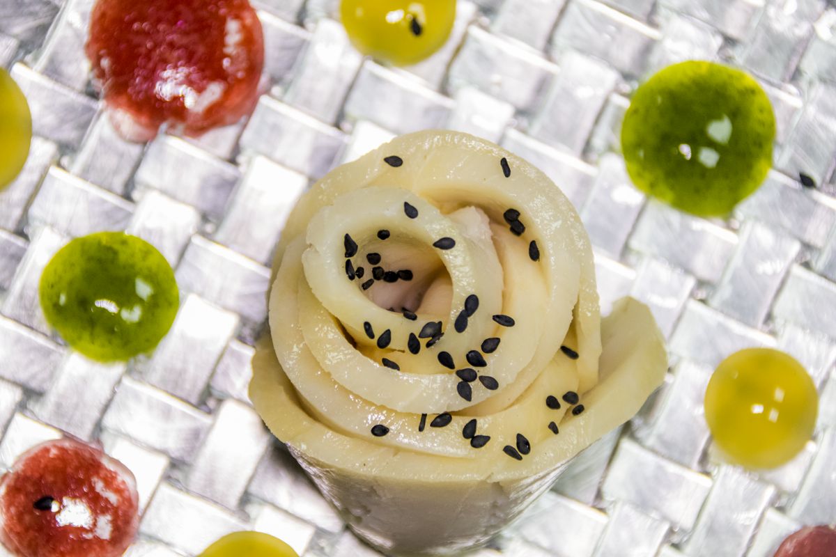 Squid roll with black sesame and coloured sauces in Tenerife.