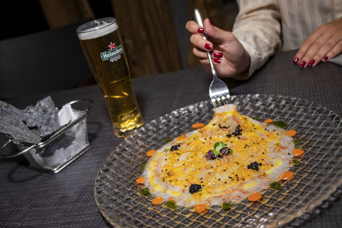 Carpaccio dish with a beer in a restaurant in Tenerife.