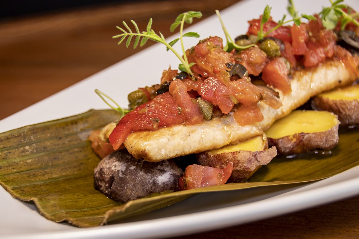 Fish with red mojo on a leaf, accompanied by potatoes in Tenerife.