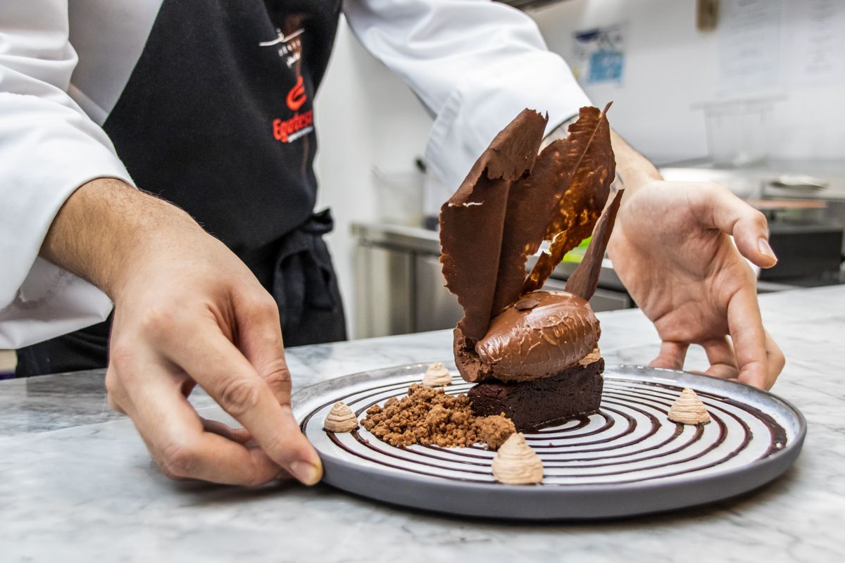 Chef decorating a chocolate dessert in Tenerife.