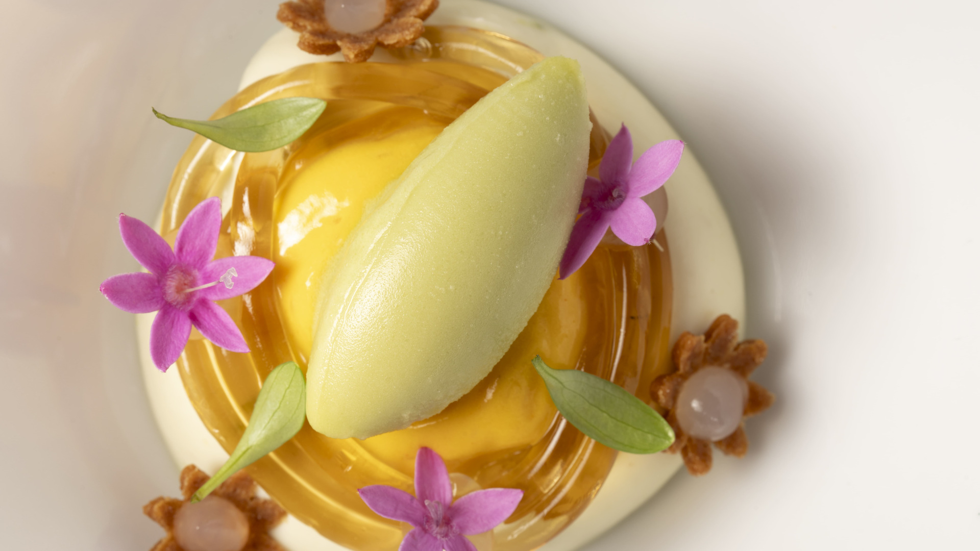 Lemon ice cream with edible flowers and small biscuits, Tenerife.