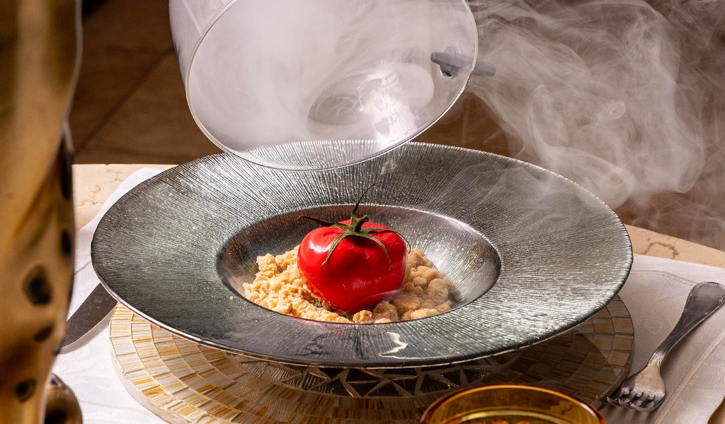 Tomato on a crumb base on a steaming plate in a restaurant in Tenerife.