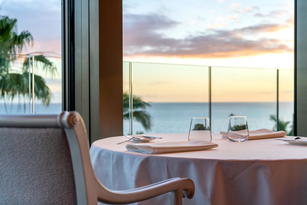 Table with glasses and napkins, sea view at sunset in a place in Tenerife.