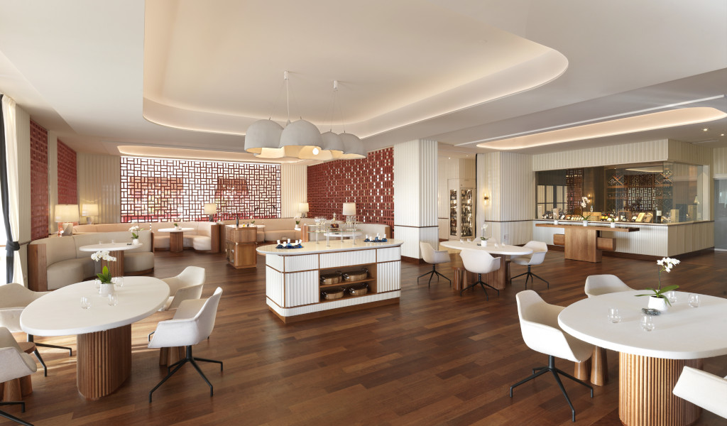 Modern restaurant with white chairs and round tables in Tenerife.