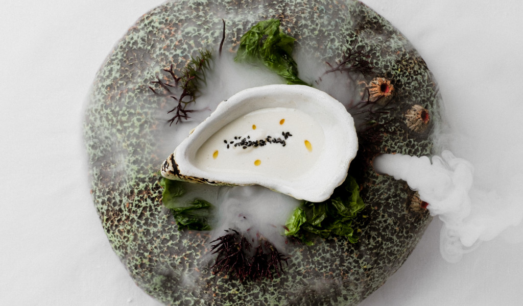 Seafood dish with white cream, seaweed and seeds in Tenerife.