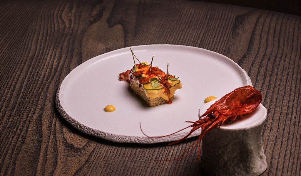 Red prawns and gourmet aperitif on a plate on a wooden table in Tenerife.