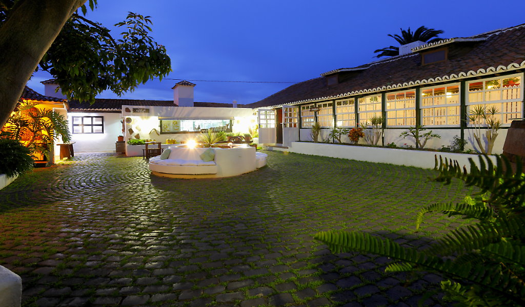 Illuminated courtyard of a traditional house in Tenerife at dusk.