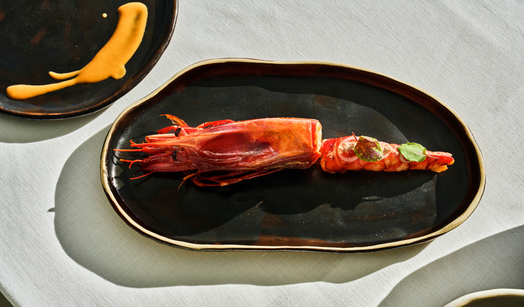 Red prawns served on a dark plate in Tenerife.