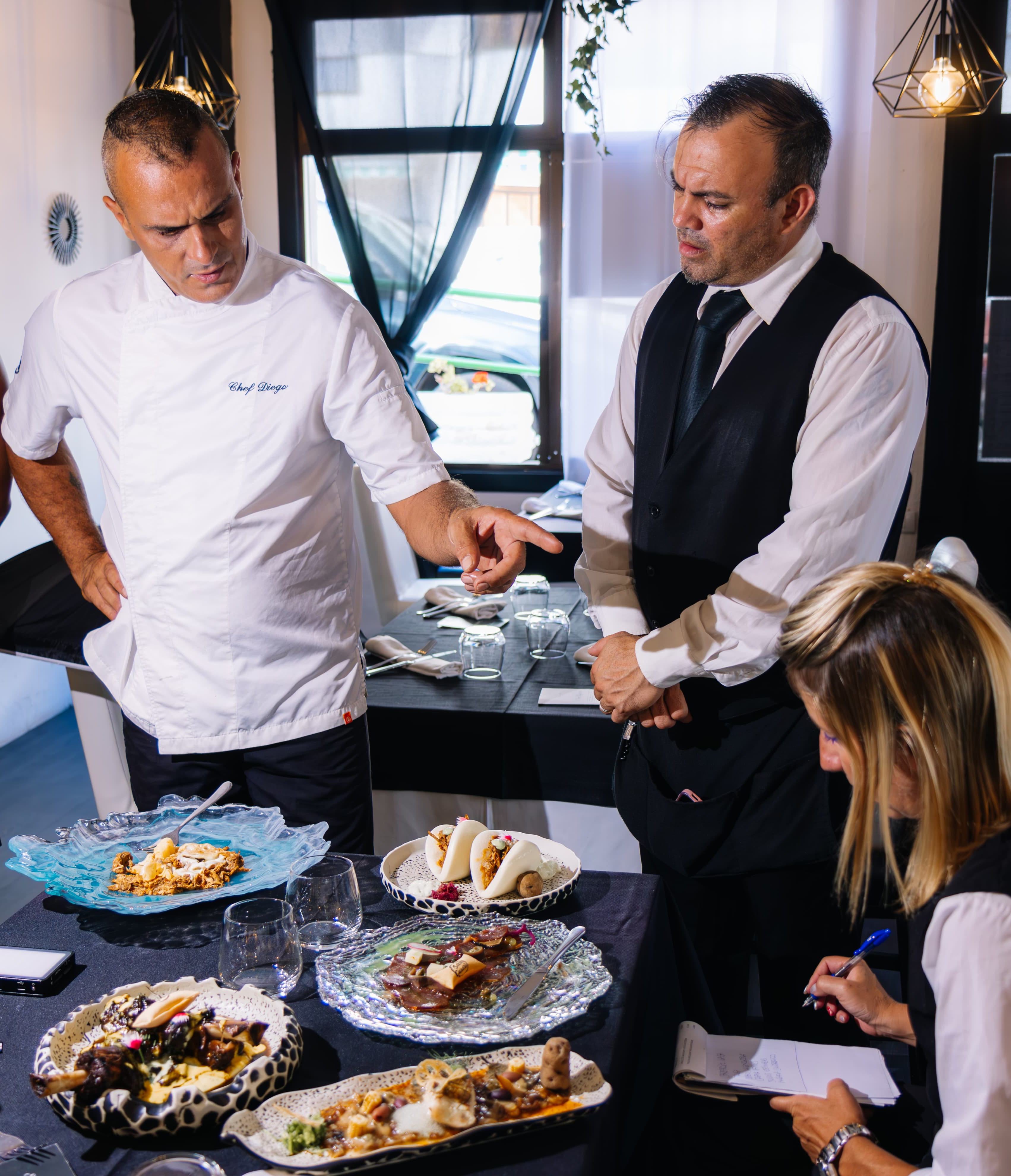 Chef and team review gourmet dishes in Puerto de la Cruz, Tenerife.