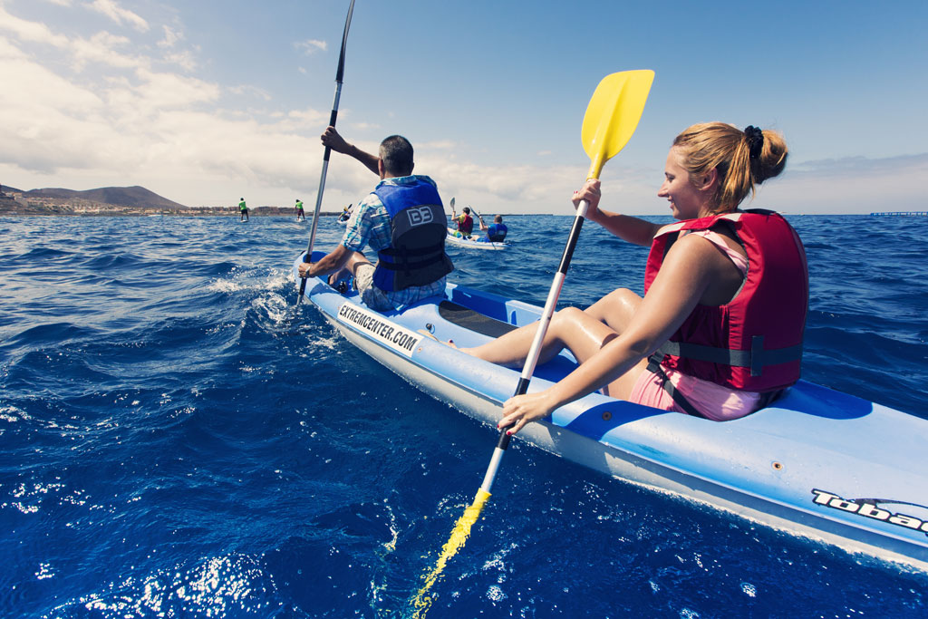 People paddling kayaks in the sea near the coast of Tenerife.