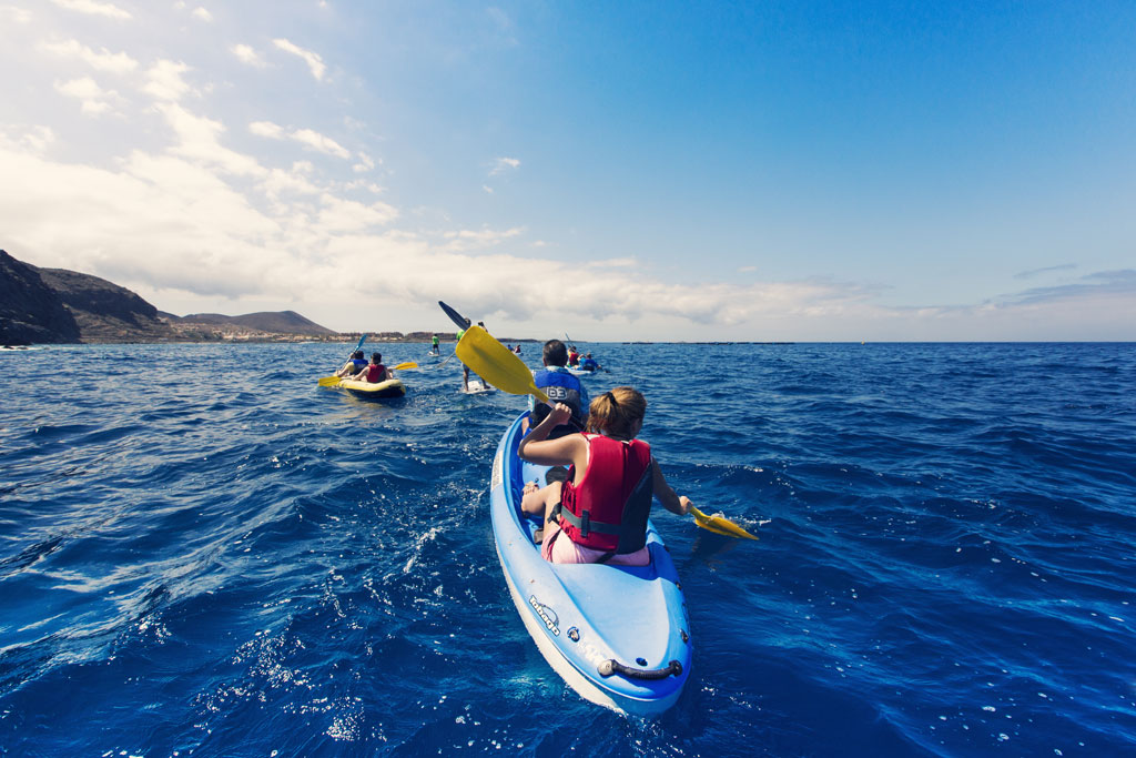 People kayaking in the sea near the coast of Tenerife.