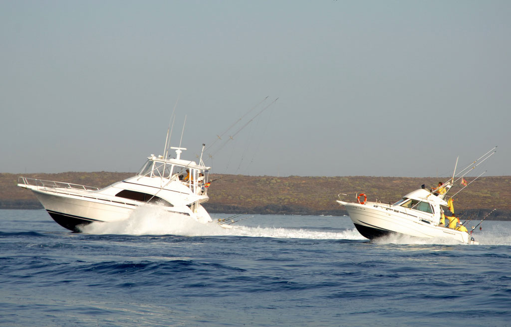 Boats sailing in the sea near Tenerife with people on board.