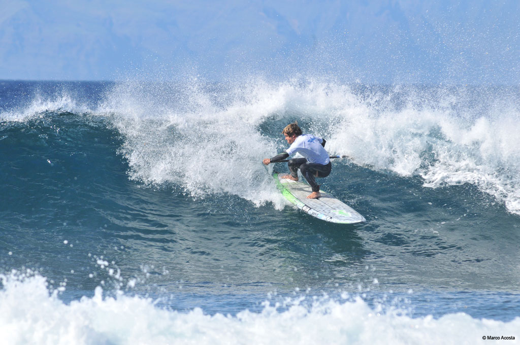 Surfer rides wave in Tenerife.