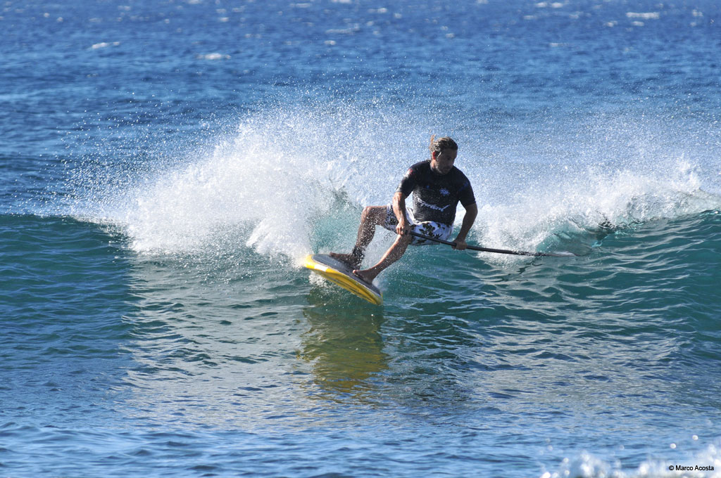 Person stand-up paddleboarding in the sea near Tenerife.