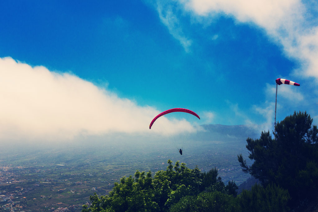 Paragliding in the sky of Tenerife over mountainous landscape?.