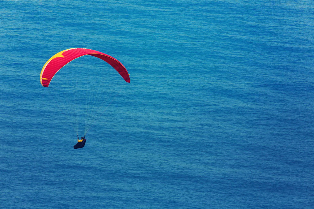 Paragliding flying over the ocean in Tenerife.