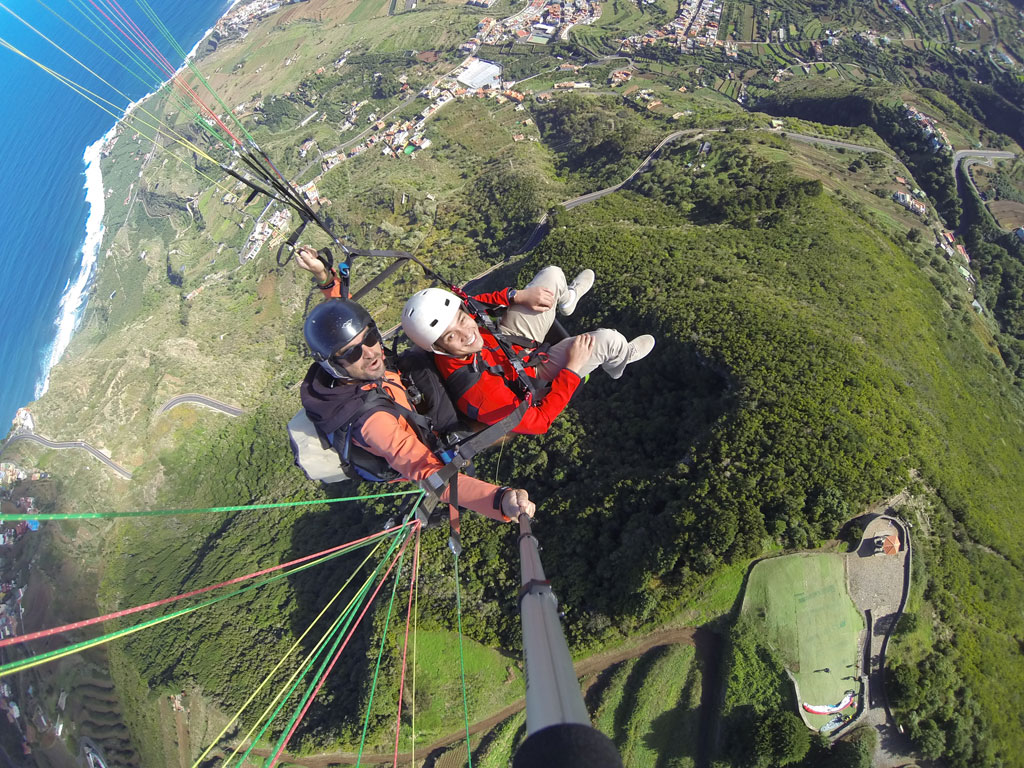 Paragliding over the coast and mountains of Tenerife, seen from above.