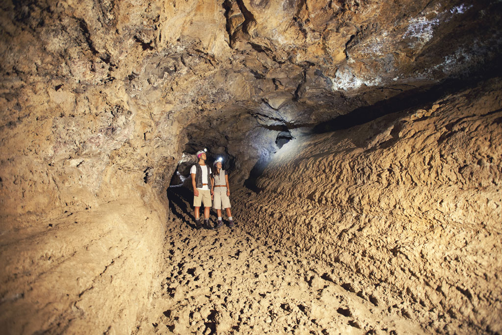 Explorers in a volcanic cave in Tenerife.