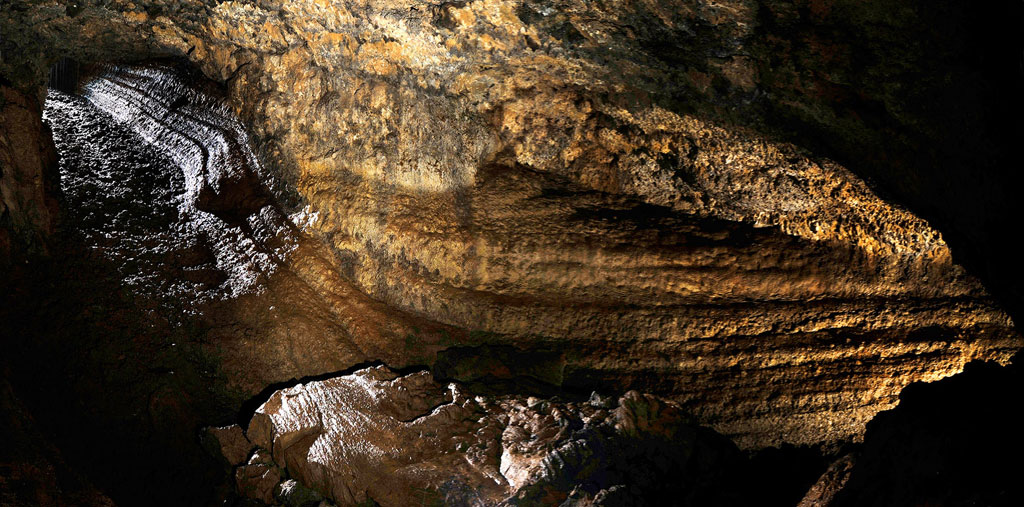Interior of the Cueva del Viento in Tenerife, showing illuminated rock formations.