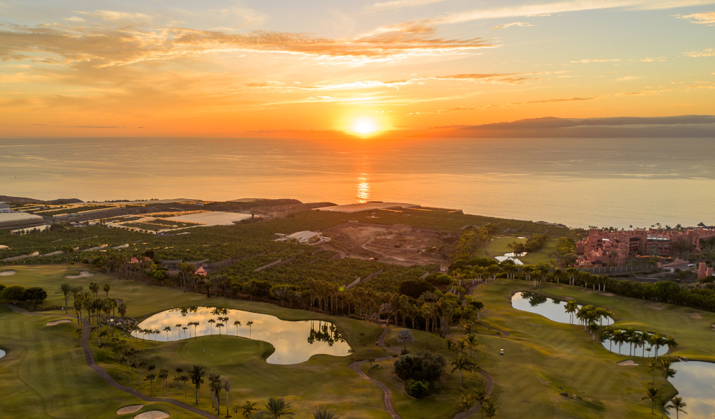 Golf course and coast at sunset in Tenerife.