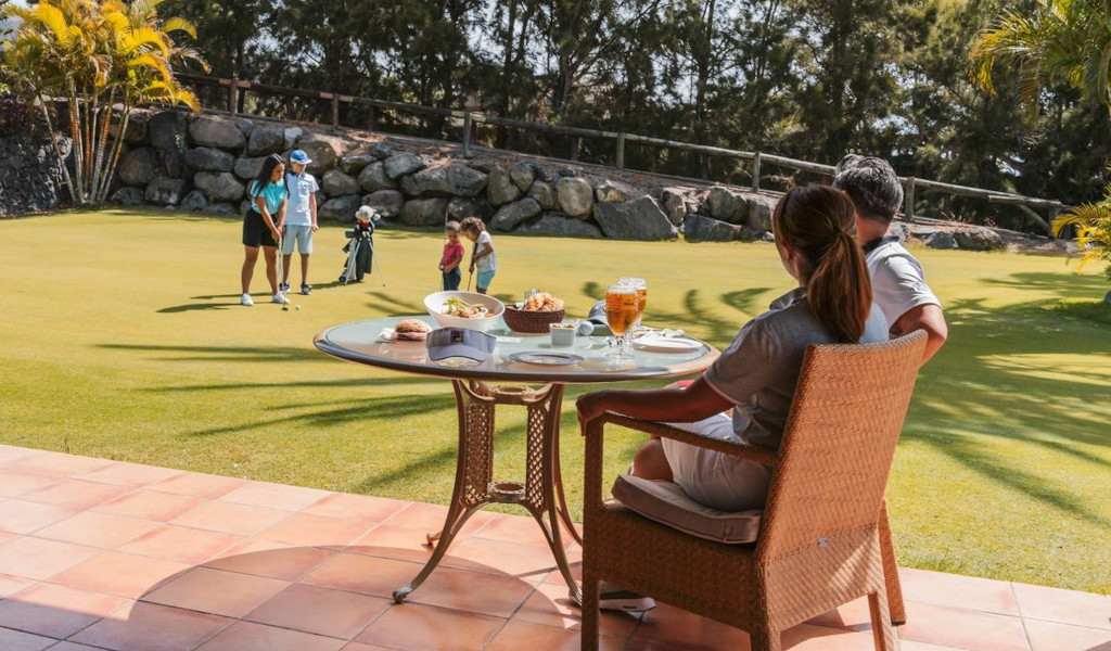 People playing golf and eating at a club in Tenerife.
